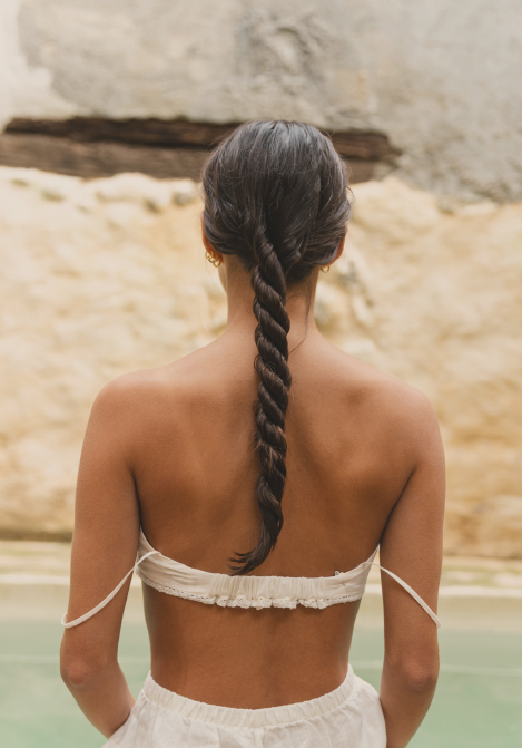 Woman seen from behind by the water